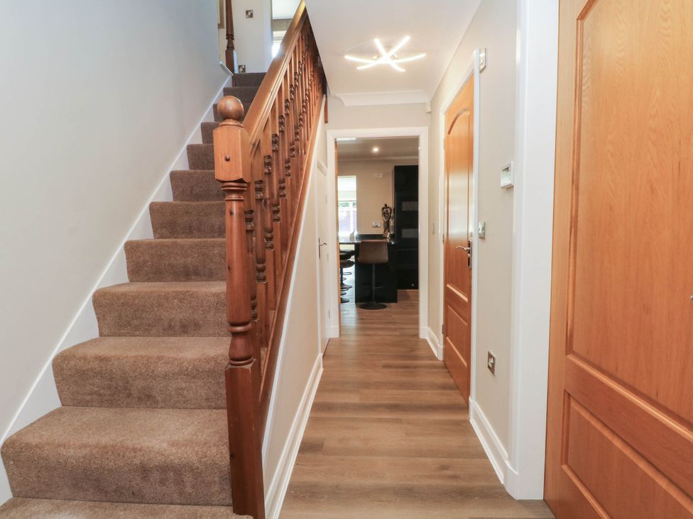 A hallway with stairs and doors at The Ferns in Kirkham