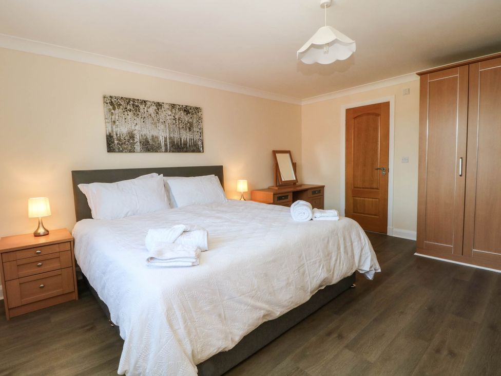 A bedroom with a bed and nightstand at The Ferns in Kirkham