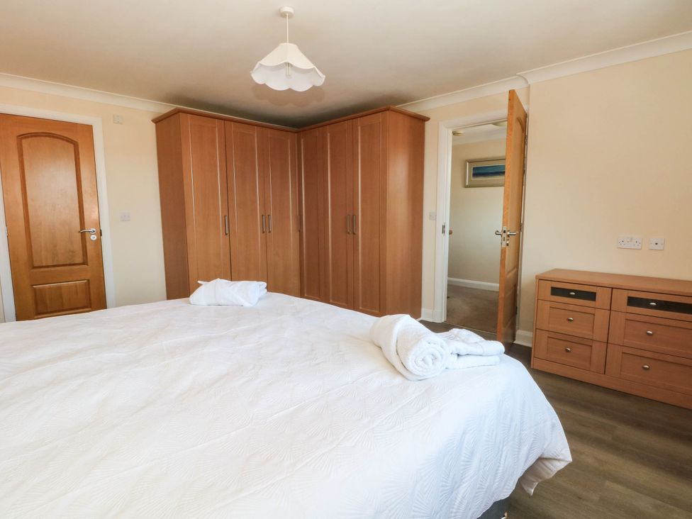 A bedroom with a bed and wardrobe at The Ferns in Kirkham
