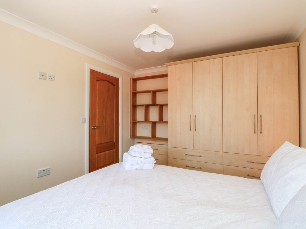 A bedroom with a bed and wardrobe at The Ferns in Kirkham
