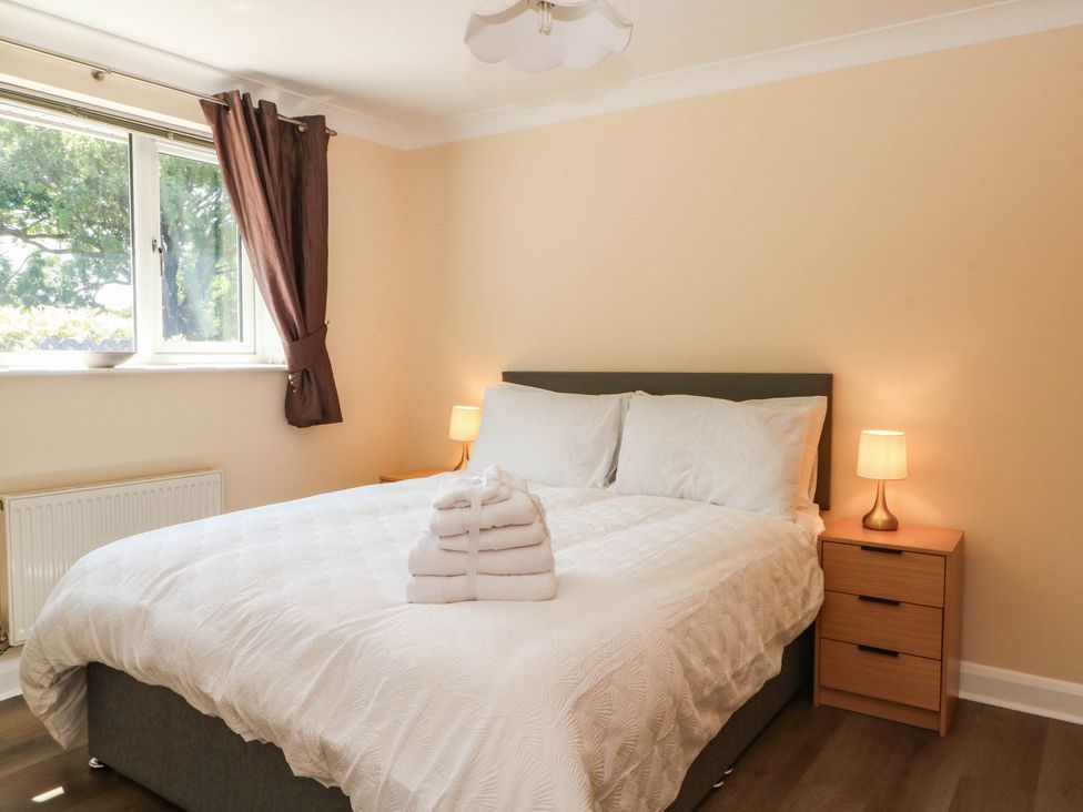 A bedroom with a bed and bedside tables at The Ferns in Kirkham