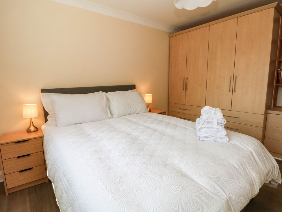 A bedroom with a bed and wardrobe at The Ferns in Kirkham