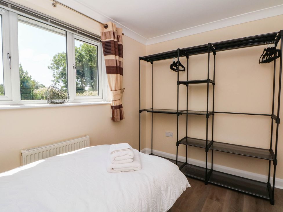 A bedroom with a bed and open shelving at The Ferns in Kirkham