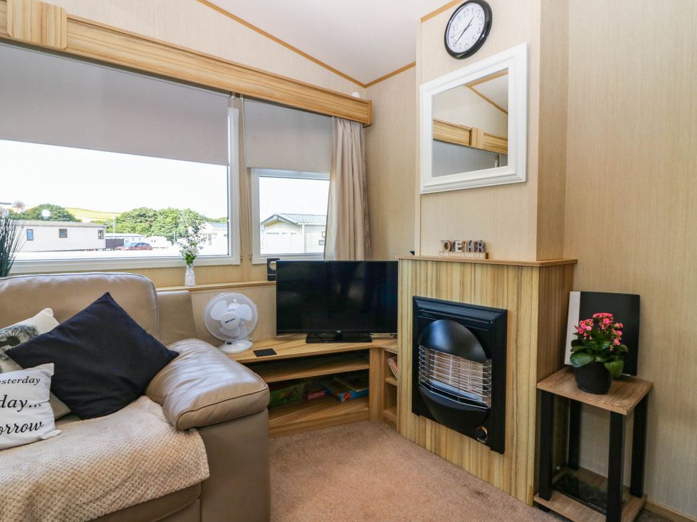 A living room with a television and fireplace at Rowan View 251