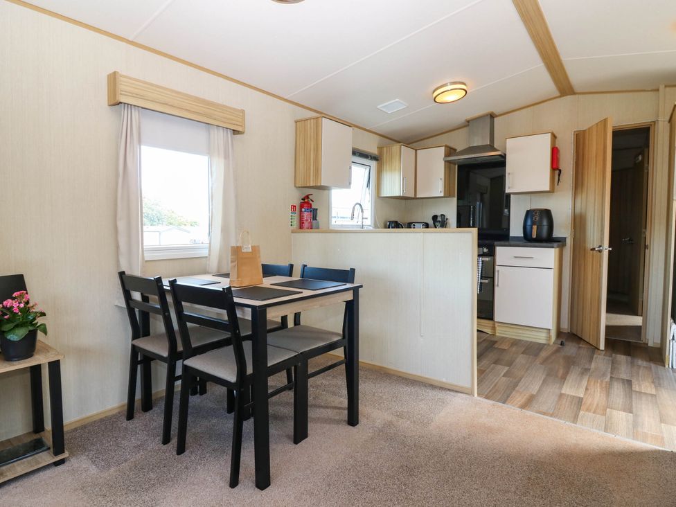 A dining area with table and chairs at Rowan View 251 