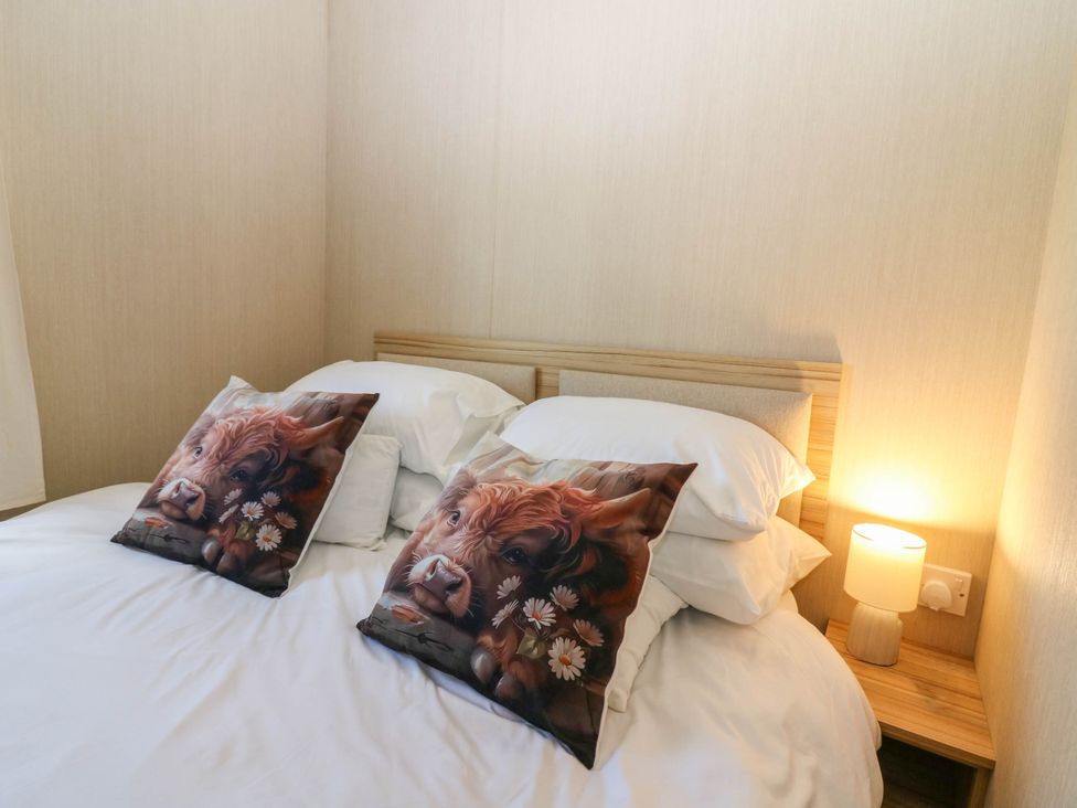 A bedroom with a double bed and two decorative pillows at Rowan View 251