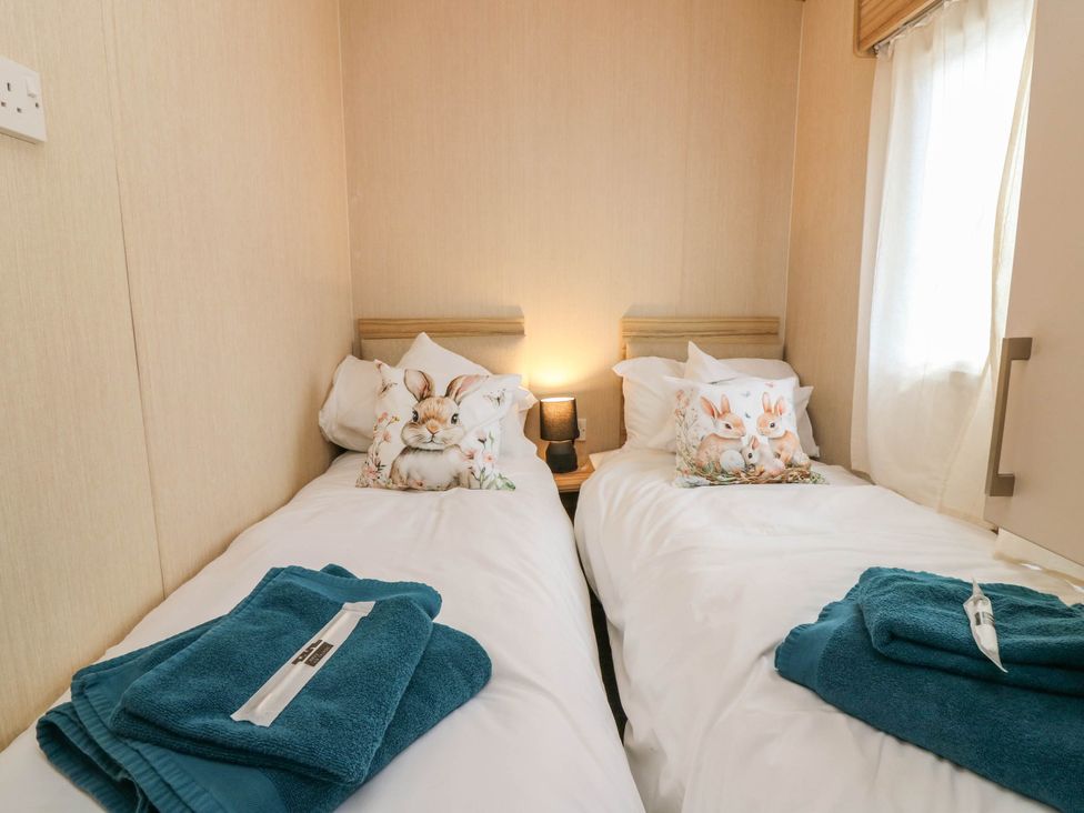 A bedroom with two beds and decorative pillows at Rowan View 251