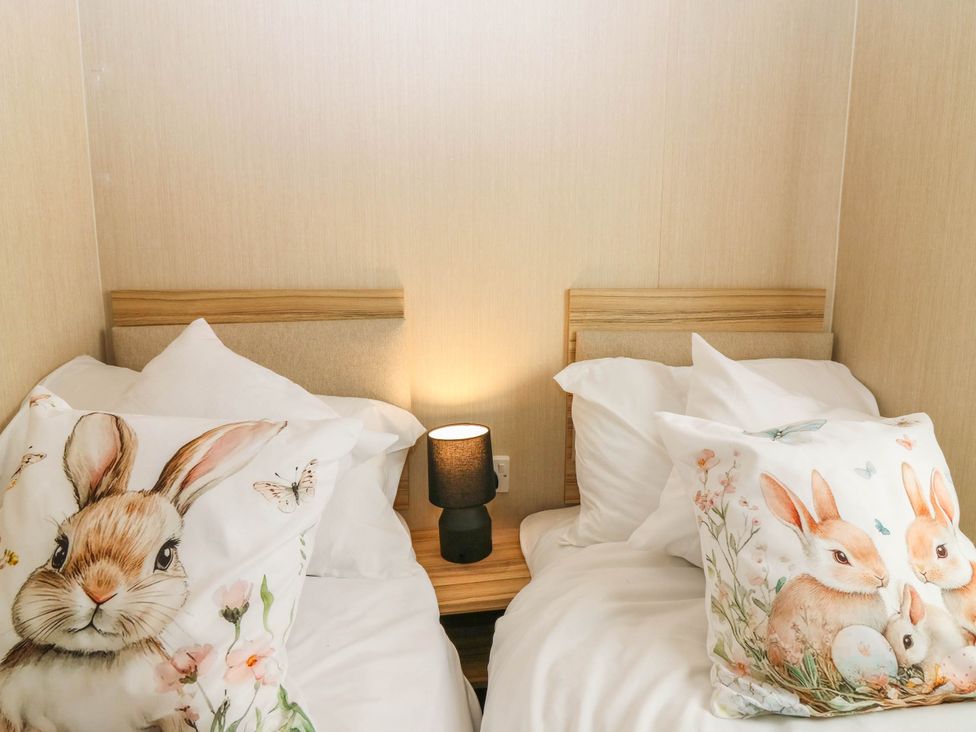 A bedroom with two beds and decorative pillows at Rowan View 251