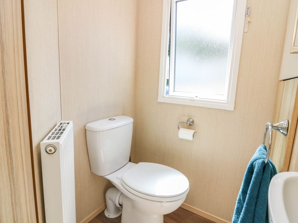 A bathroom with a toilet and window at Rowan View 251