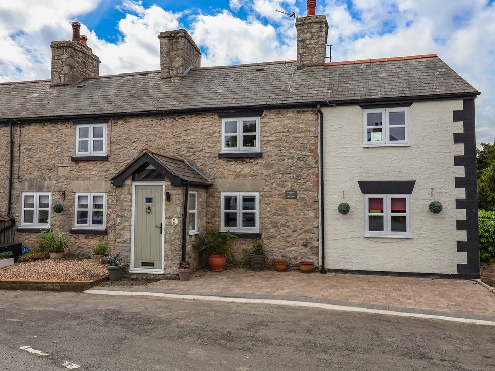 A house with a front door and windows at Tenandeleven Cottage in Denbigh