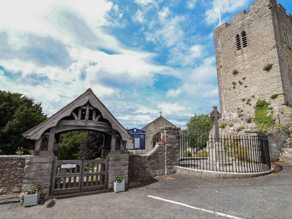 A church with a cross and gate at Tenandeleven Cottage in Denbigh