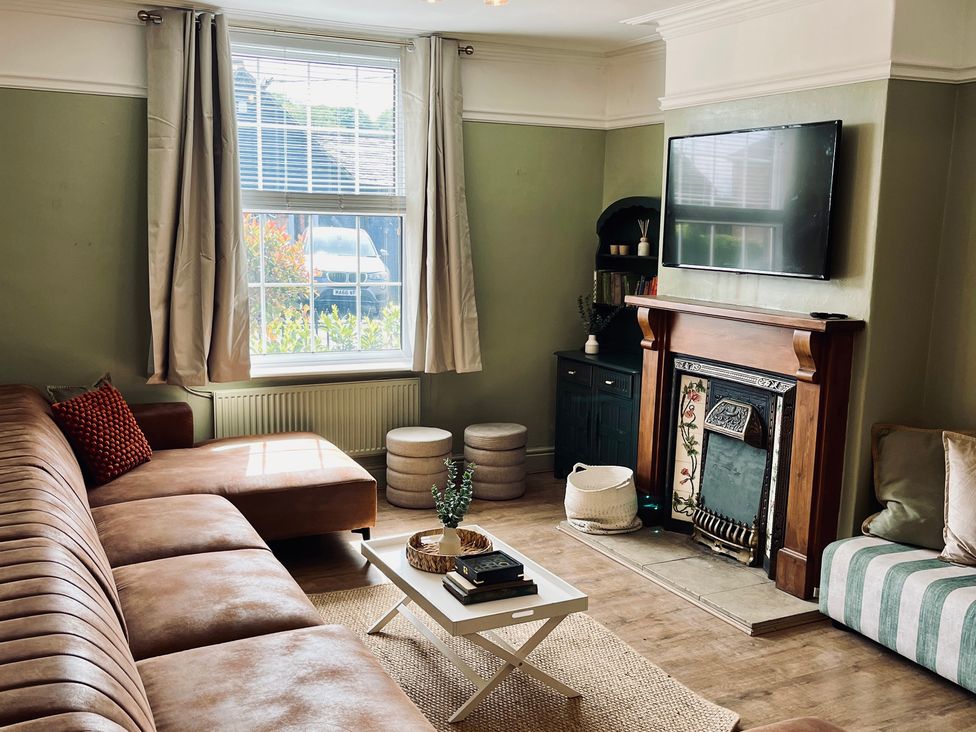 A living room with a sofa and coffee table at Horseshoe Cottage in Macclesfield