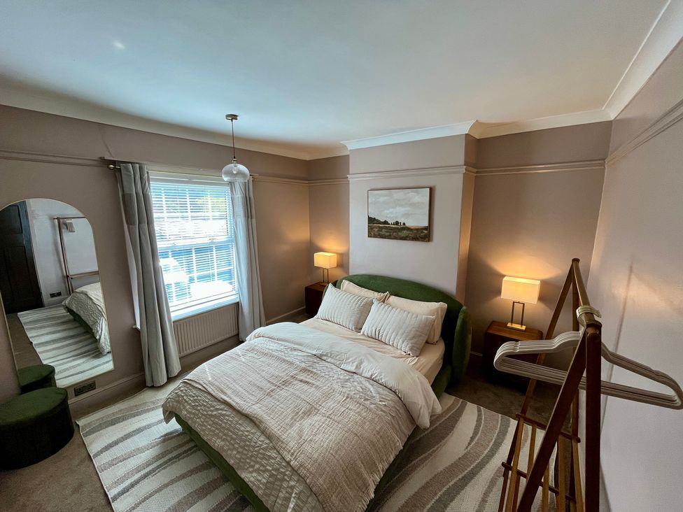 A bedroom with a bed and a window at Horseshoe Cottage in Macclesfield