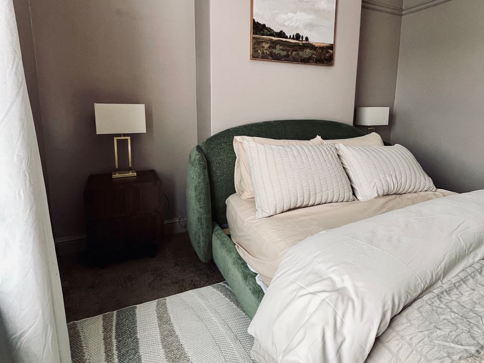 A bedroom with a bed and nightstand at Horseshoe Cottage in Macclesfield