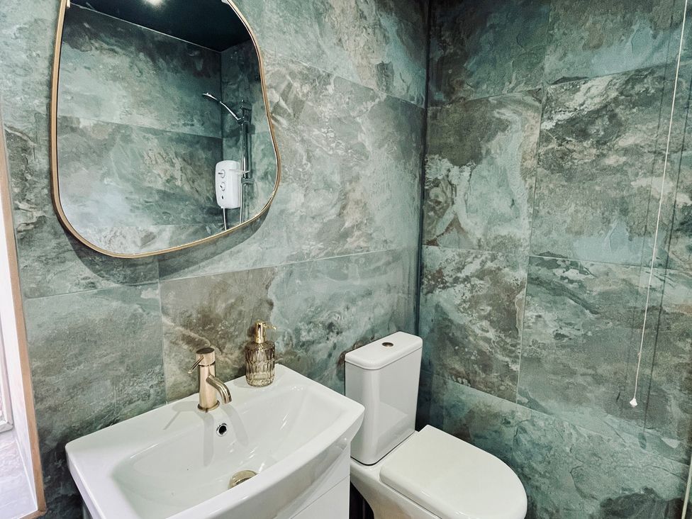 A bathroom with a sink and toilet at Horseshoe Cottage in Macclesfield