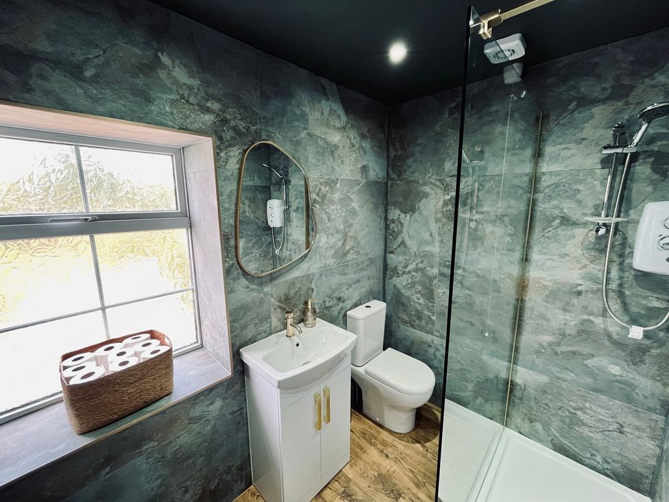 A bathroom with a sink and shower at Horseshoe Cottage in Macclesfield