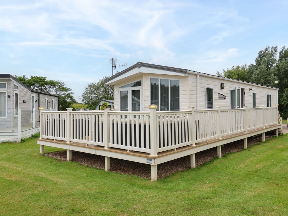 A mobile home with deck and railing at Finch 66 in Scarborough