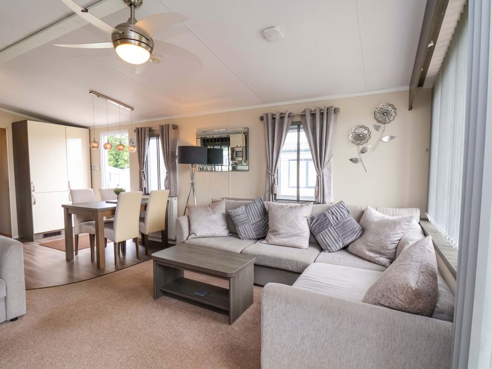 A living room with a sofa and a dining table at Finch 66 in Scarborough