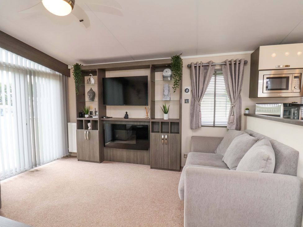 A living room with a television and sofa at Finch 66 in Scarborough