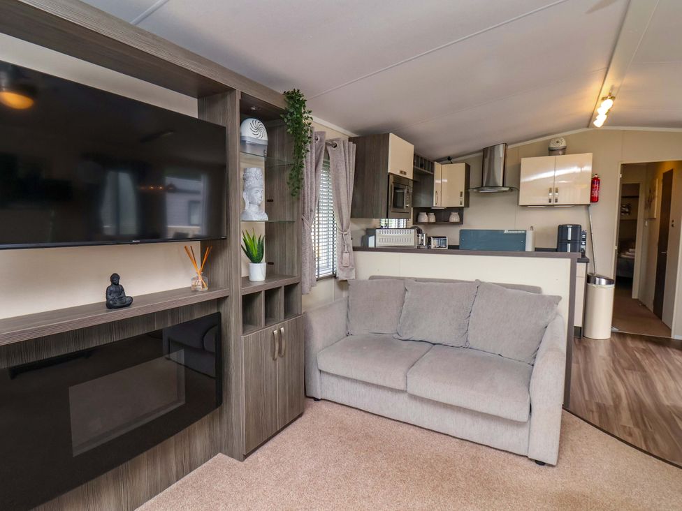 A living room with a couch and television at Finch 66 in Scarborough