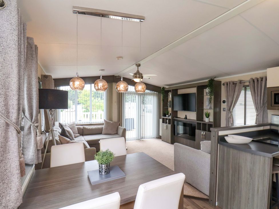 A living room with a sofa and dining table at Finch 66 in Scarborough