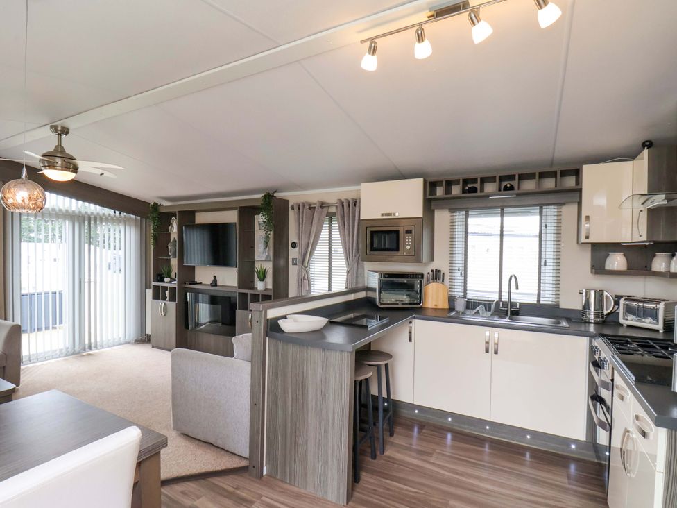 A living room with a kitchen area at Finch 66 in Scarborough
