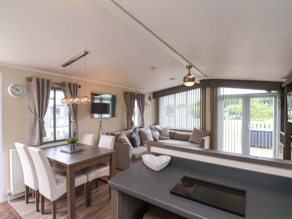 A living room with a dining area and sofa at Finch 66 in Scarborough