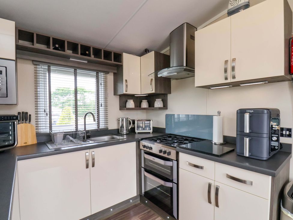 A kitchen with sink and appliances at Finch 66 in Scarborough
