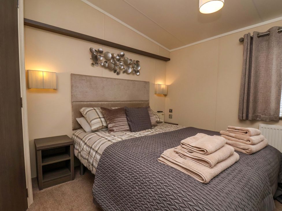 A bedroom with a bed and bedside table at Finch 66 in Scarborough