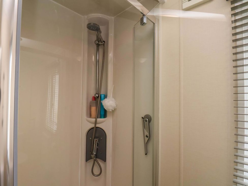A shower with a shower head and toiletries at Finch 66 in Scarborough
