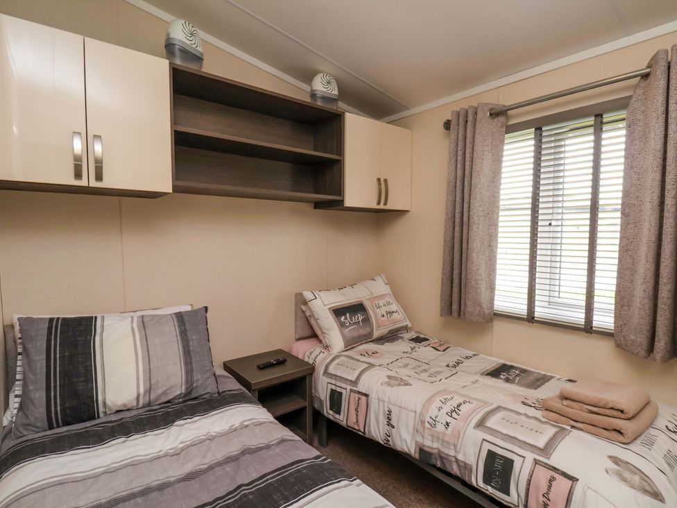 A bedroom with two beds and a window at Finch 66 Scarborough