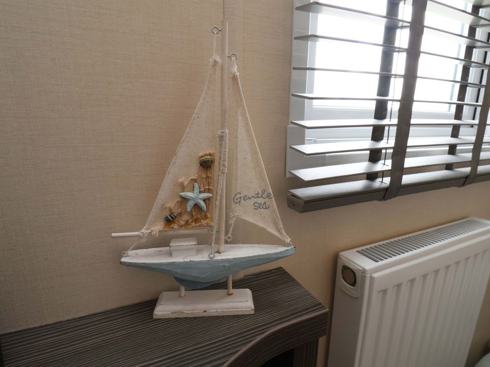 A decorative sailing boat with starfish in a room at Finch 66 in Scarborough