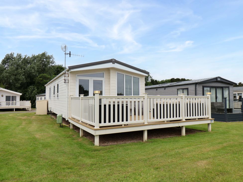 A mobile home with a veranda and garden area at Finch 66 Scarborough