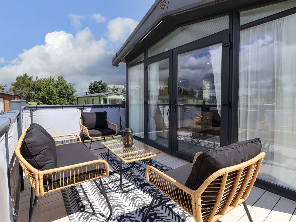 A balcony with seating and table at Lodge - Plot 18 Near Sherburn