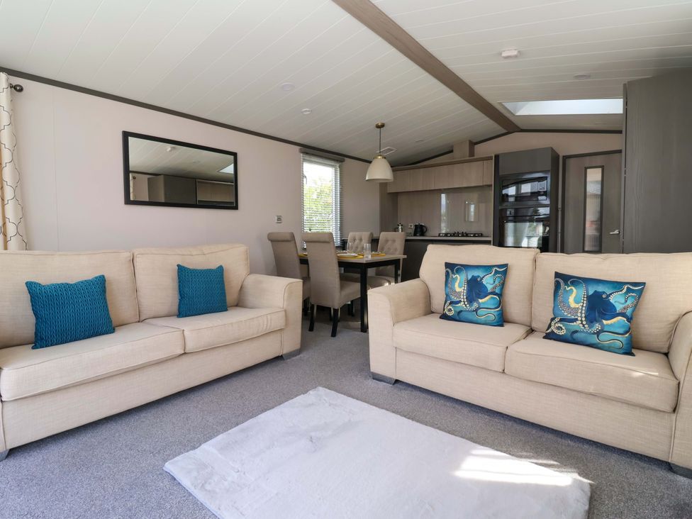 A living room with sofas and a dining area at Lodge - Plot 18 near Sherburn