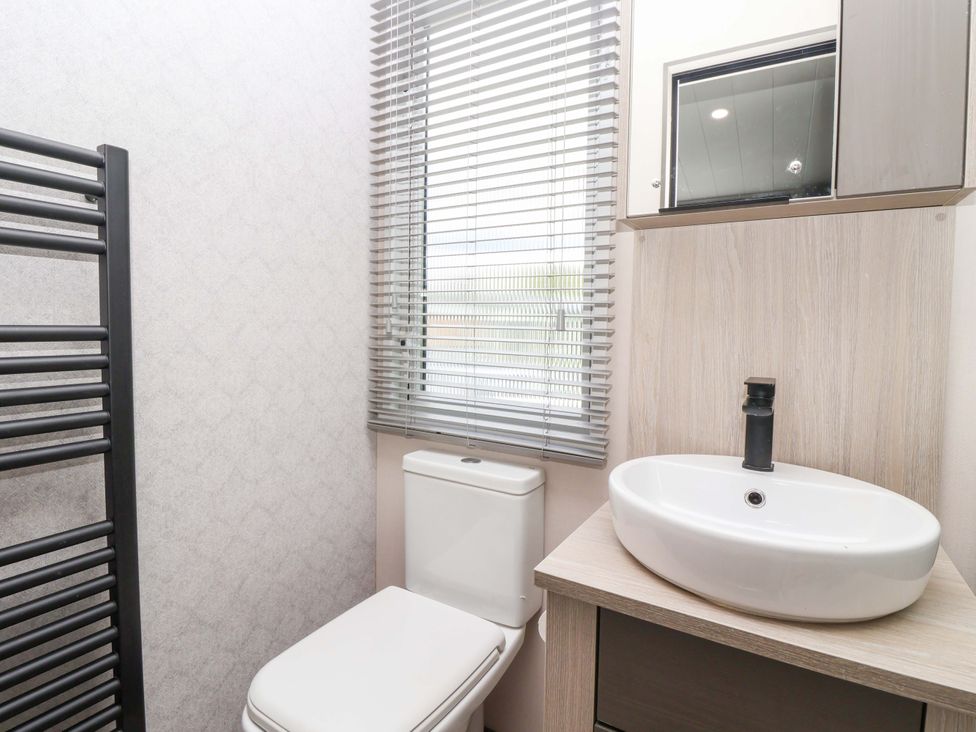 A bathroom with a toilet and sink at Lodge - Plot 18 Near Sherburn
