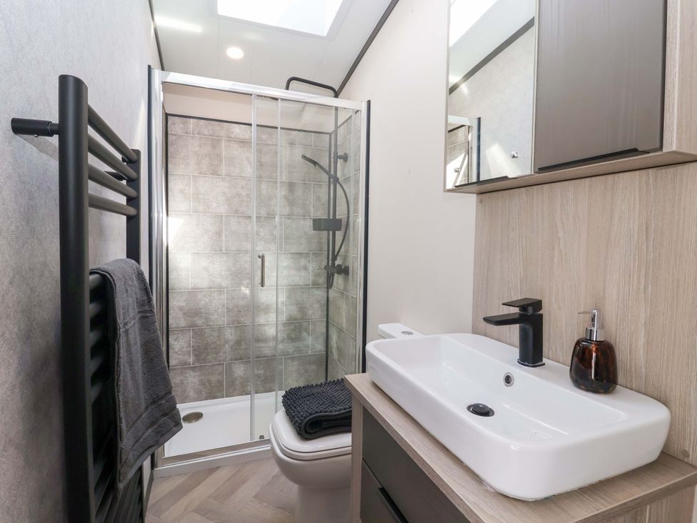 A bathroom with shower, toilet, sink, and towel rail at Lodge - Plot 18 Near Sherburn