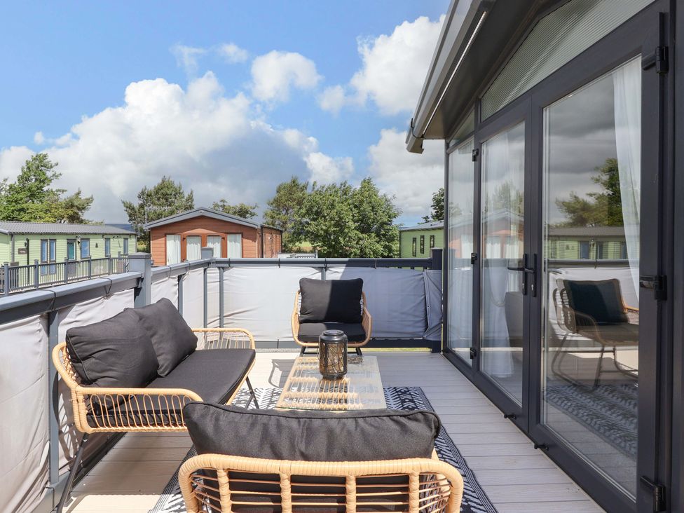 An outdoor terrace with a sofa and coffee table at Lodge - Plot 18 Near Sherburn