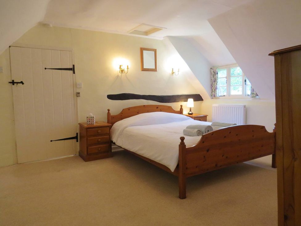 A bedroom with a bed and bedside tables at Little Owl High Cross near Petersfield