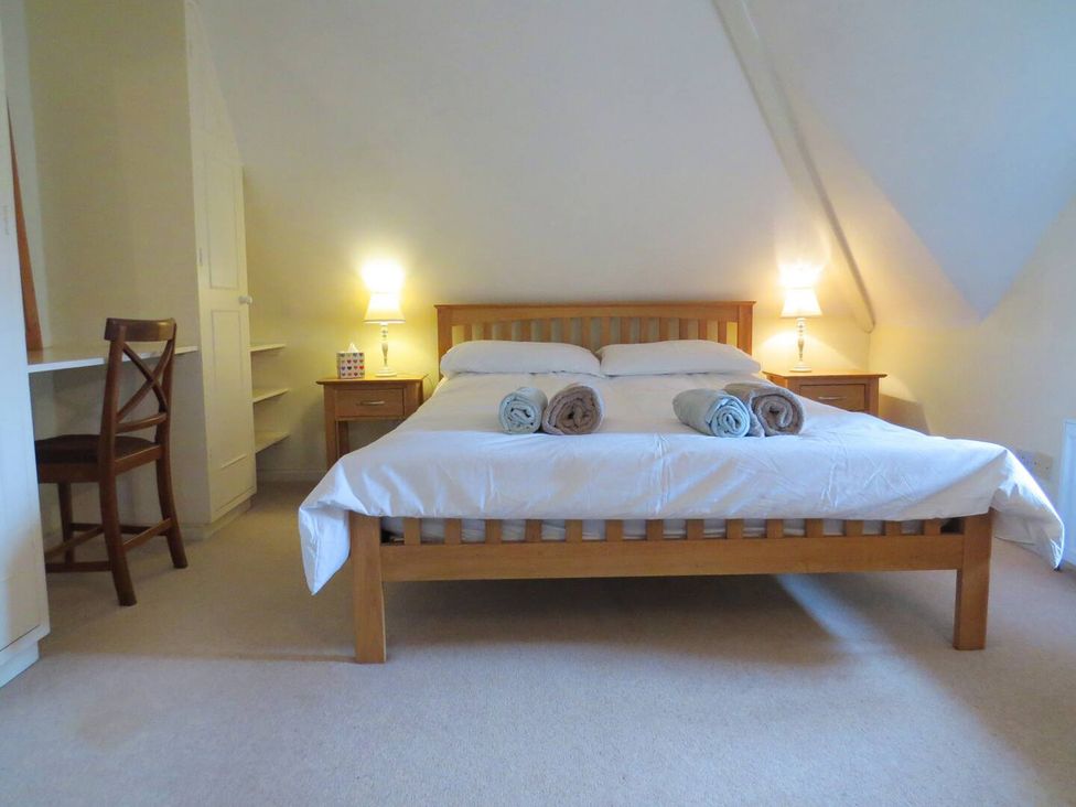 A bedroom with a bed and desk at Little Owl High Cross near Petersfield