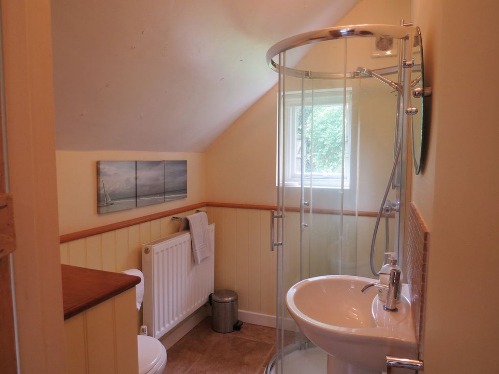 A bathroom with a shower, toilet, and sink at Little Owl in High Cross near Petersfield