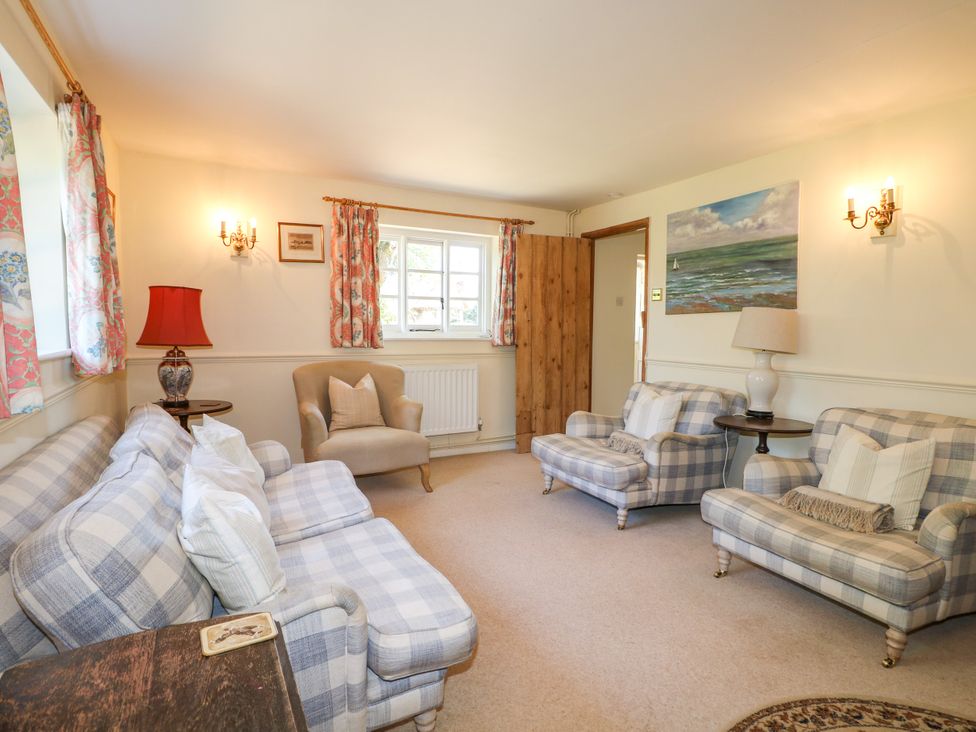 A living room with a couch and armchair at Little Owl High Cross near Petersfield