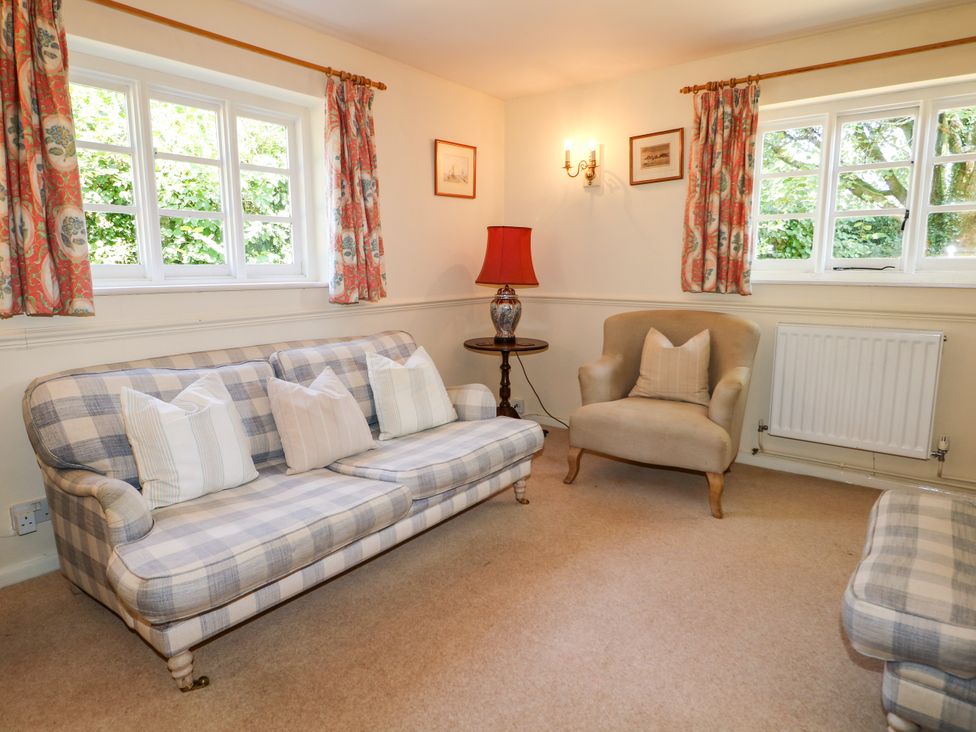 A living room with a sofa and armchair at Little Owl in High Cross near Petersfield