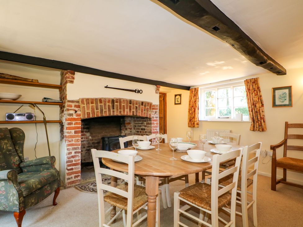 A dining room with a table set for meals at Little Owl in High Cross near Petersfield
