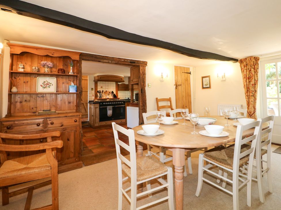 A dining room with a table set for a meal at Little Owl High Cross near Petersfield