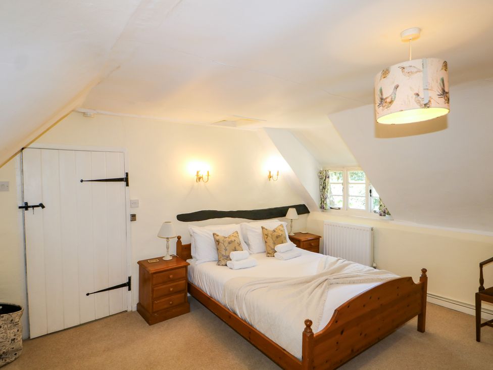 A bedroom with a bed and nightstand at Little Owl High Cross near Petersfield