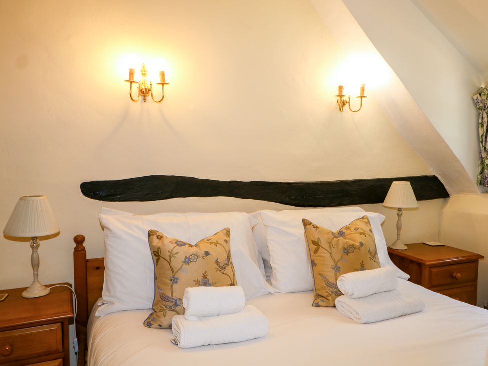 A bedroom with a bed and bedside tables at Little Owl High Cross near Petersfield