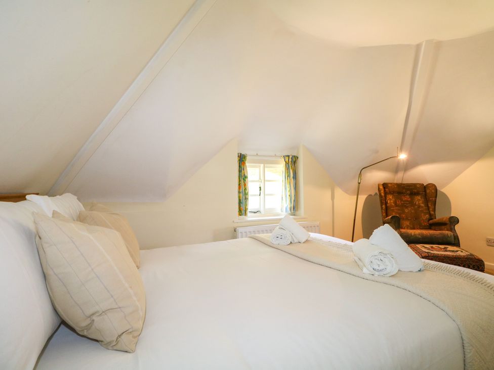A bedroom with a bed and a chair at Little Owl High Cross near Petersfield
