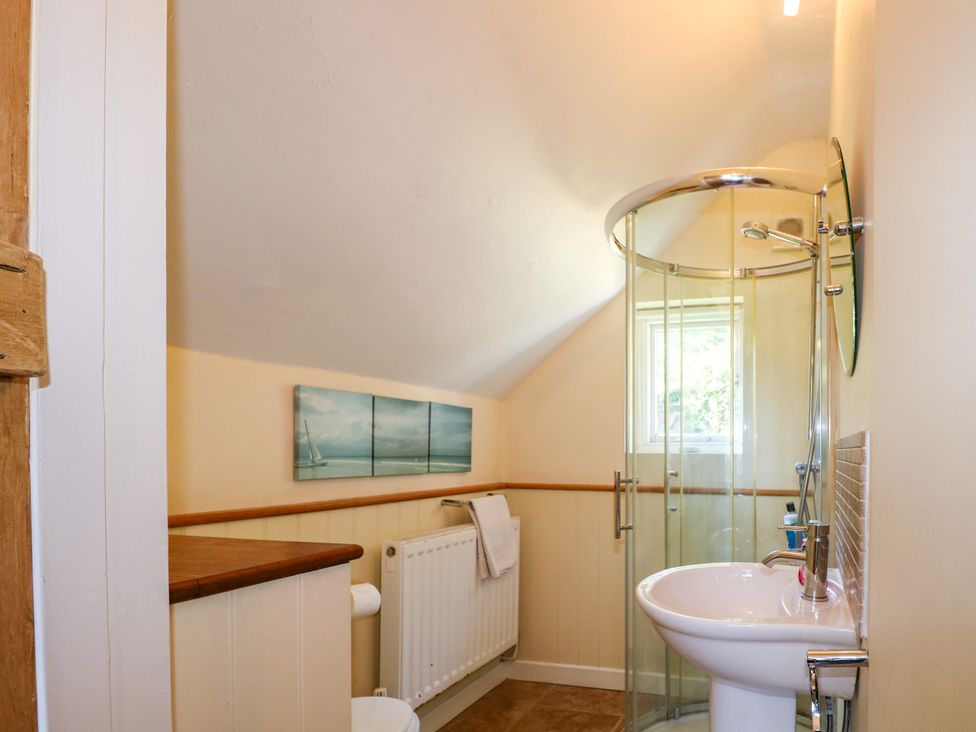 A bathroom with a shower and sink at Little Owl High Cross near Petersfield