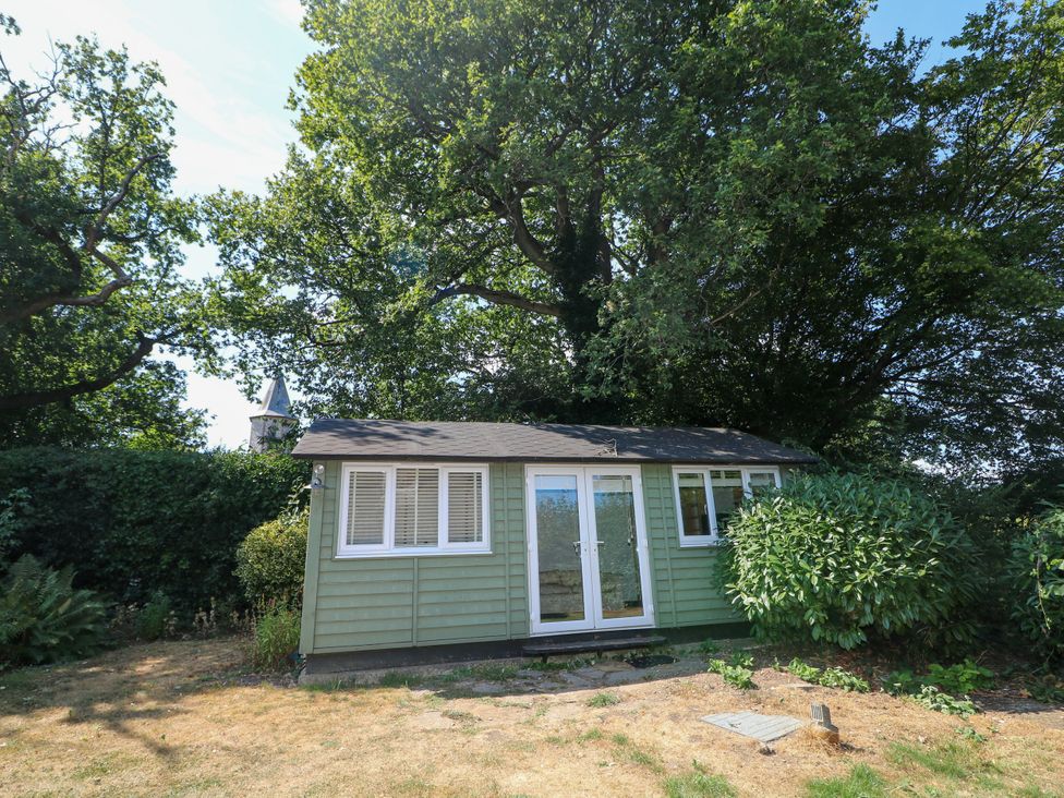 A garden shed surrounded by trees at Little Owl in High Cross near Petersfield